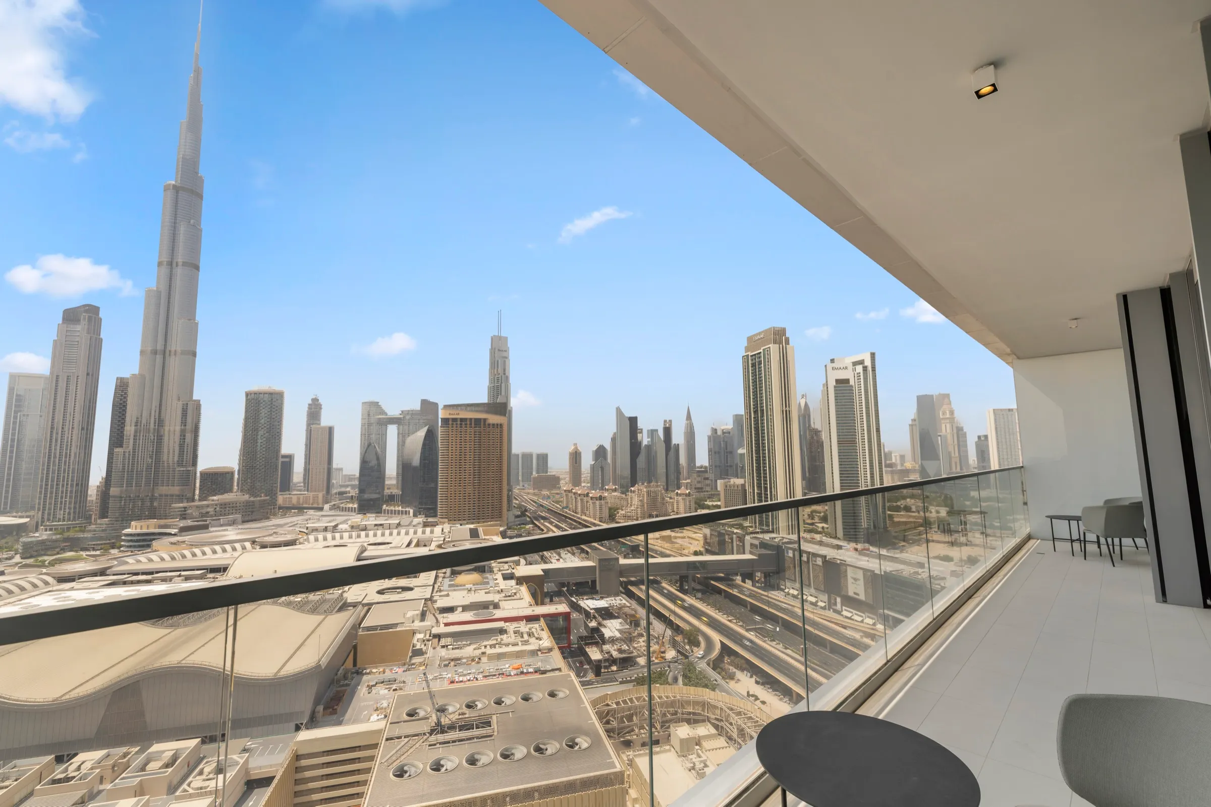 A furnished apartment terrace looking across Dubai towards the Burj Khalifa