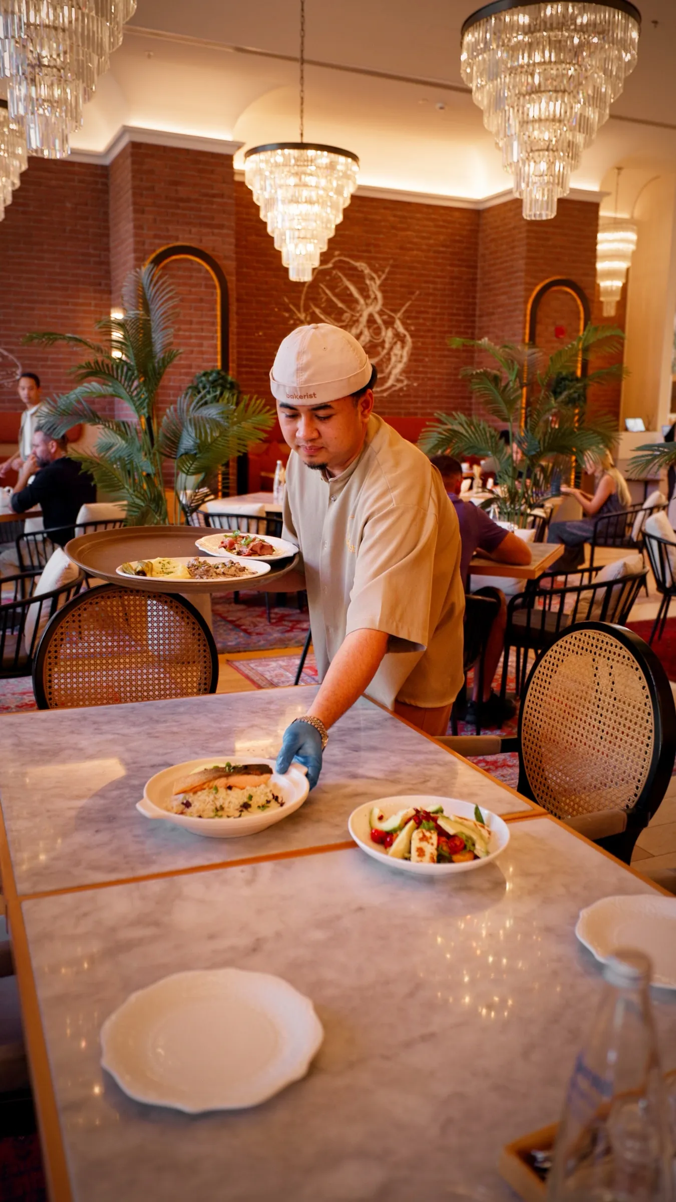 A chef plating a dish in a styled kitchen setting