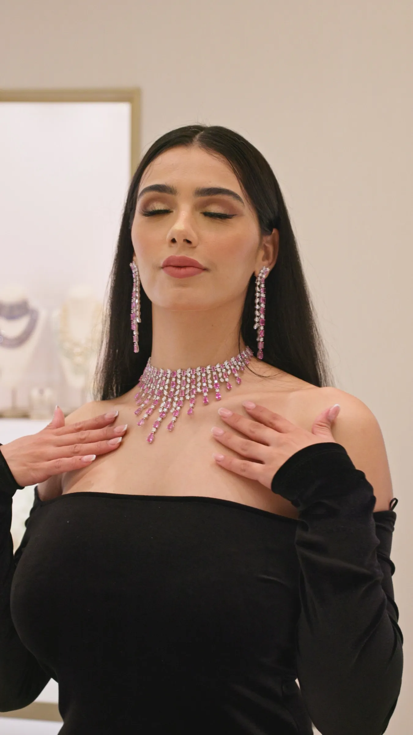 A studio portrait of a model wearing a statement diamond necklace