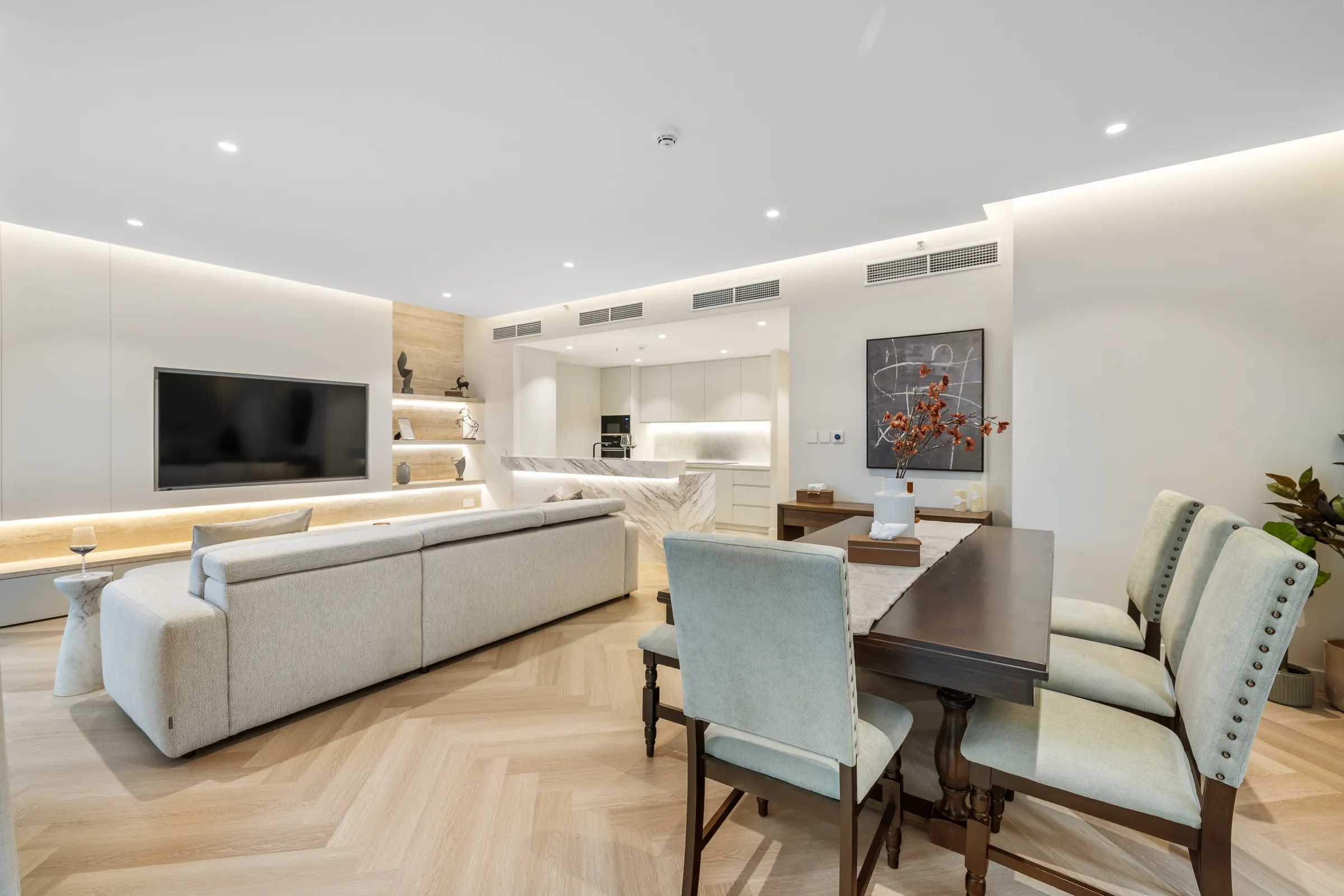 A furnished residence dining and living space with natural light