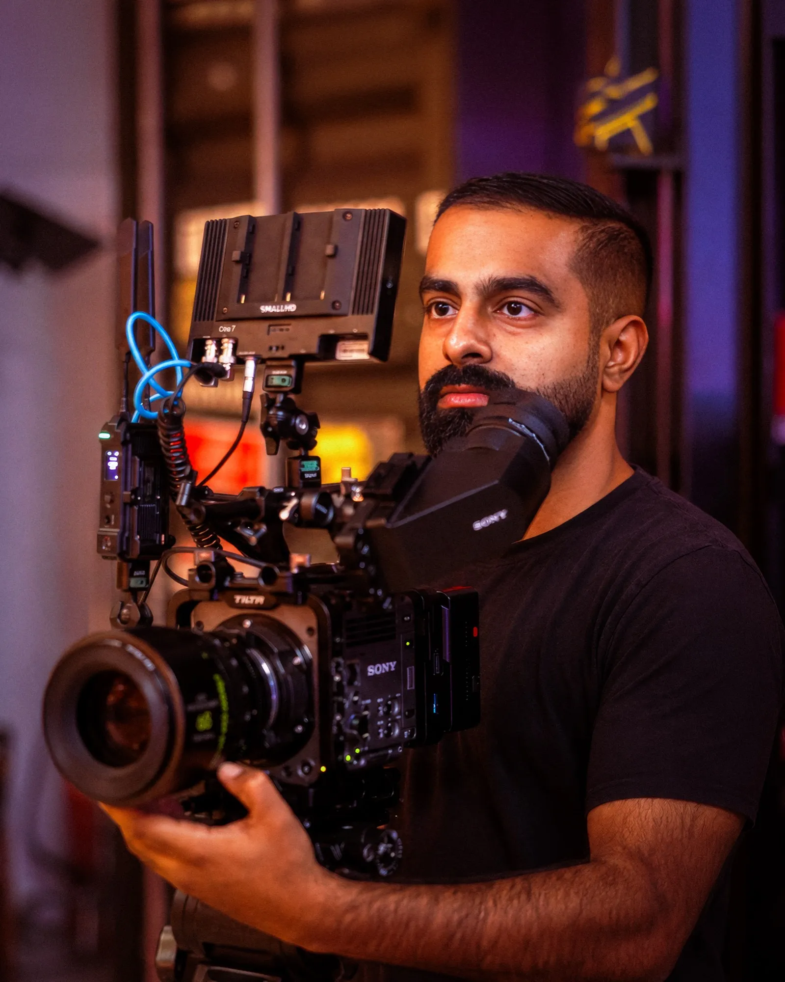 Sagar Rathod, founder of Fire Lens Productions, holding a cinema camera on set