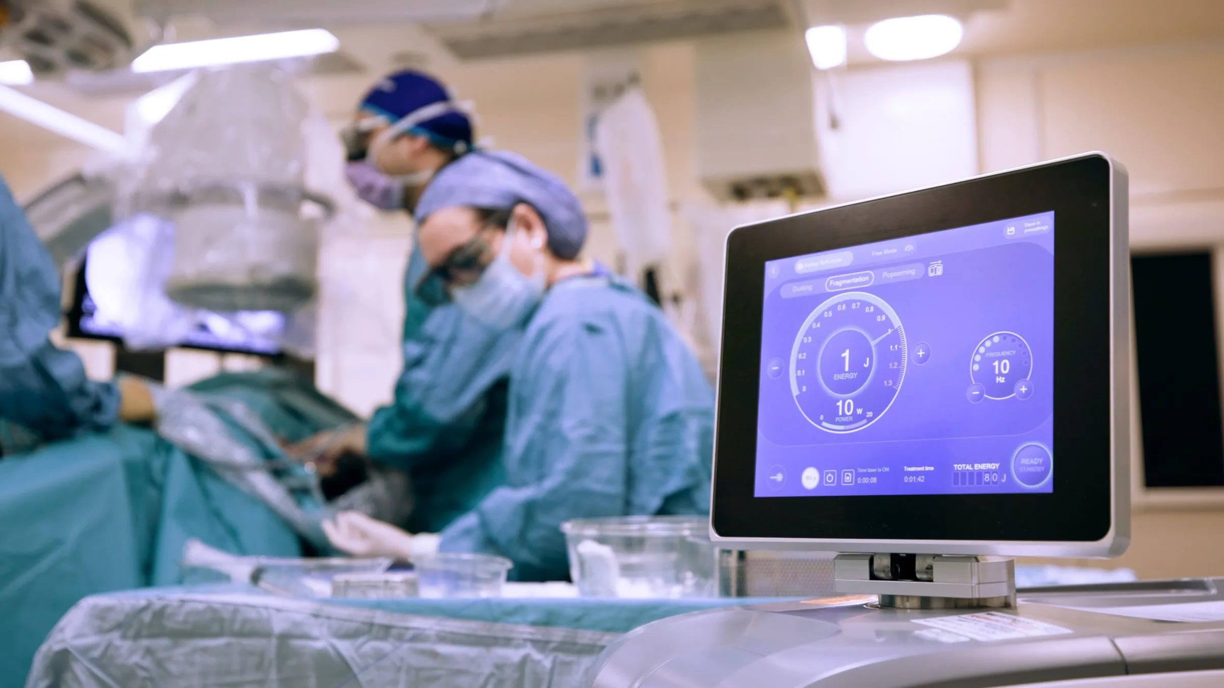 A live surgery relayed to a wall-mounted monitor in an operating theatre
